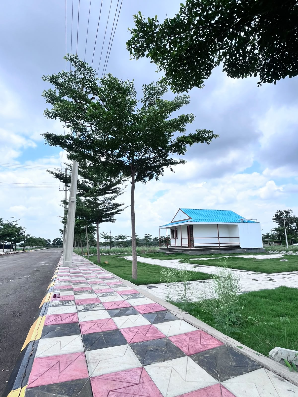 Club house style building and plot-side road
